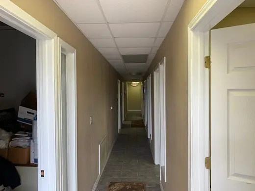 Bright hallway leading to rooms in an intensive outpatient program in Houston.