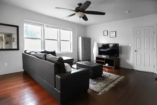 Bright living room with modern furnishings at Emancipation House, a men's sober living home in Houston.