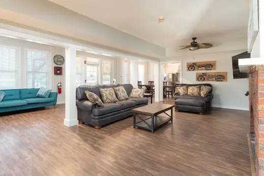 Spacious living room with comfortable sofas in a sober living home in Houston.