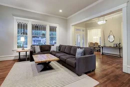 Cozy living room with sectional sofa at Transcend Recovery Community, a sober living home in Houston.