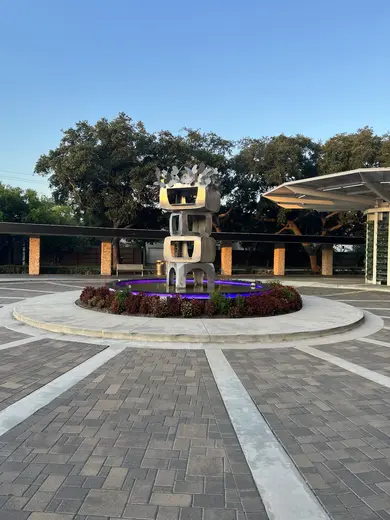 Sculptural fountain surrounded by landscaping at Harris Health Rehabilitation Services at Fournace, treatment center in Houston.