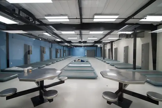 Spacious common area with seating and beds at treatment center in Houston.