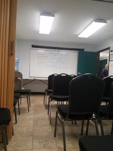 Empty meeting room with chairs at Assoc for the Adv of Mexican Amer Inc, a treatment center in Houston.